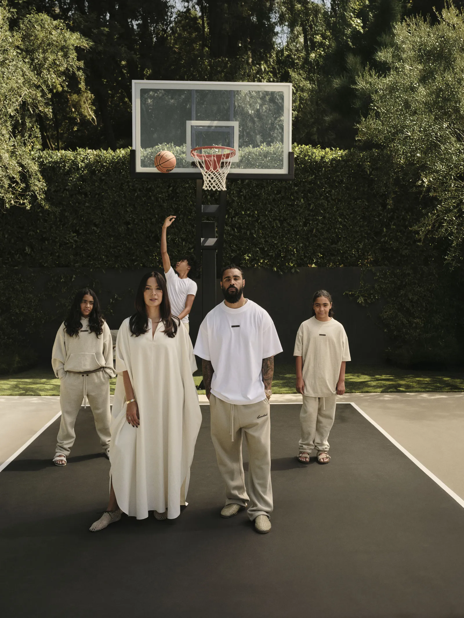 View to the poolside pergola. Mathieu Matégot chairs and Willy Guhl planters flank the entry to the kitchen from the garden.